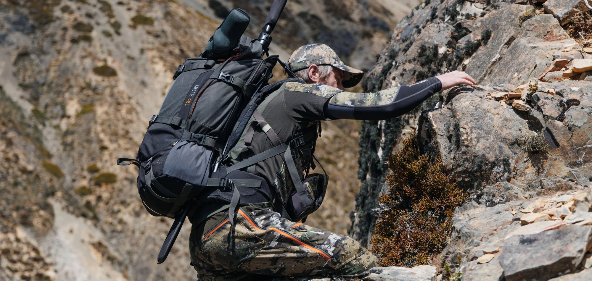 hunter climbing wearing hunters element pack and gear